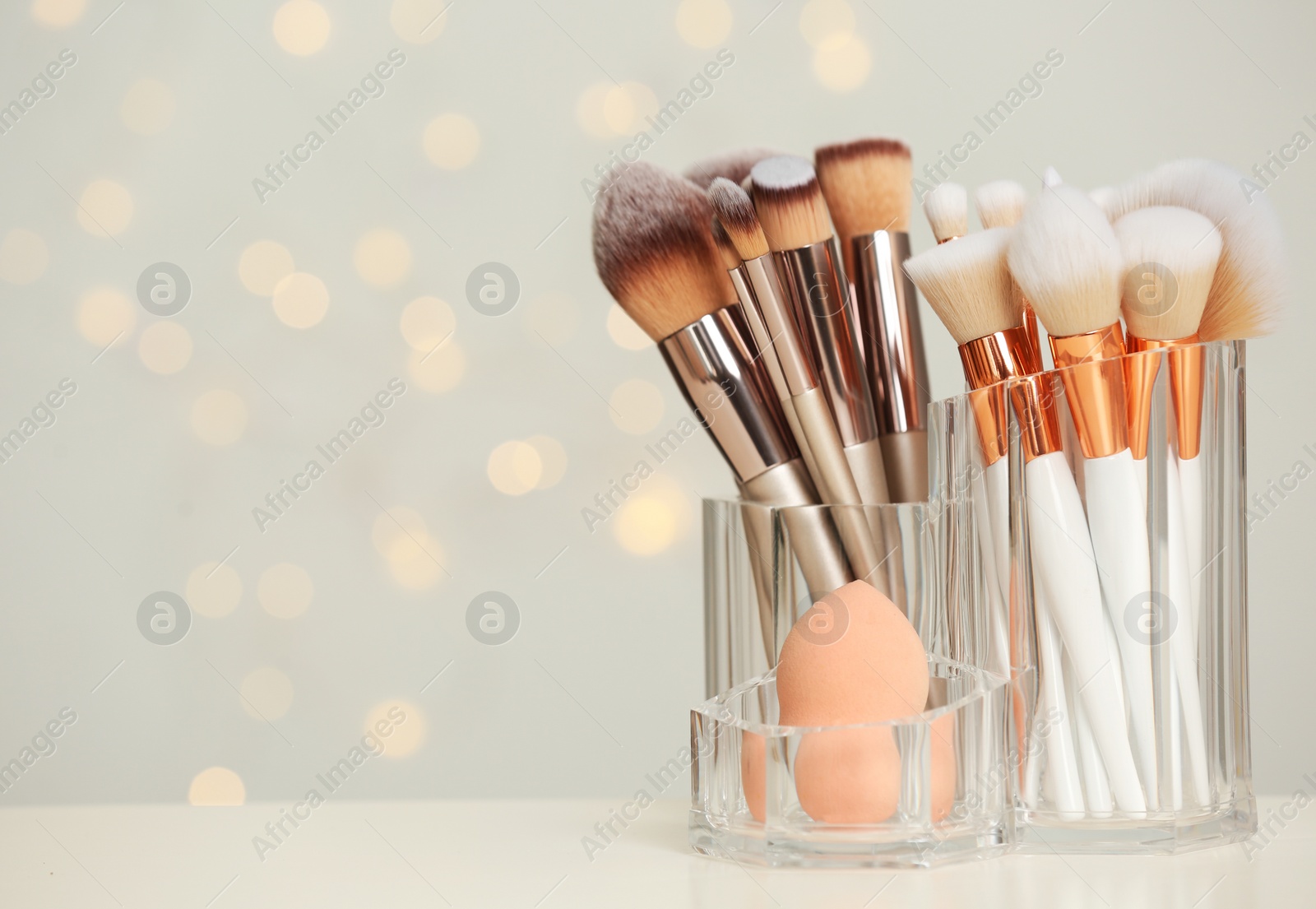 Photo of Organizer with beauty accessories on table. Space for text