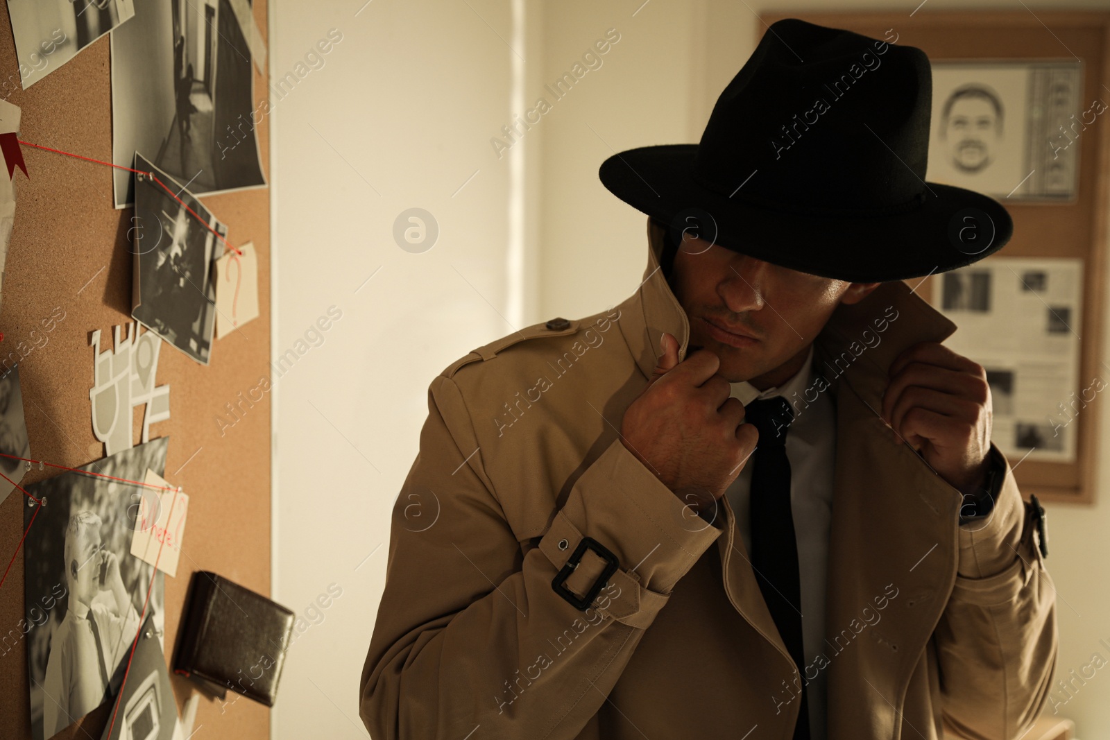 Photo of Detective near evidence board in his office