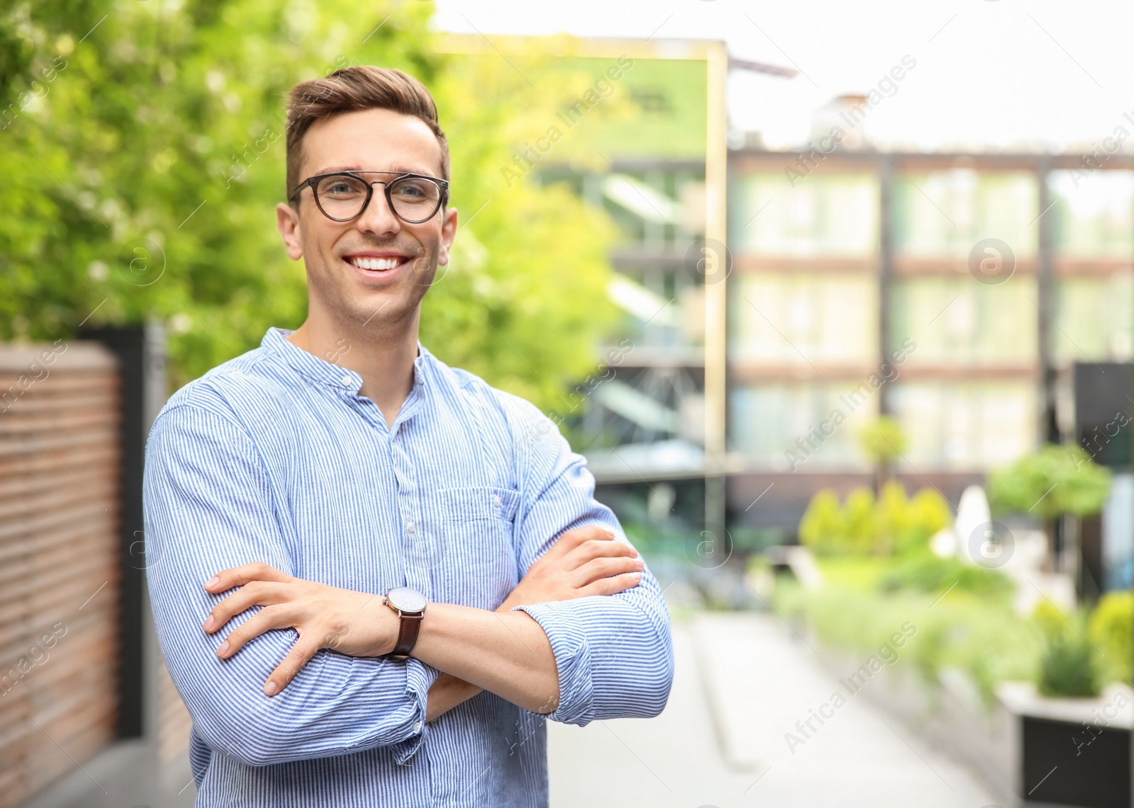 Photo of Portrait of attractive young man in stylish outfit outdoors