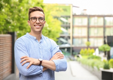 Portrait of attractive young man in stylish outfit outdoors