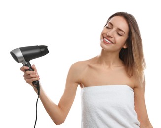 Beautiful young woman using hair dryer on white background