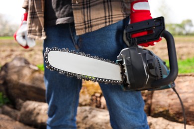 Photo of Man with modern saw on sunny day, closeup