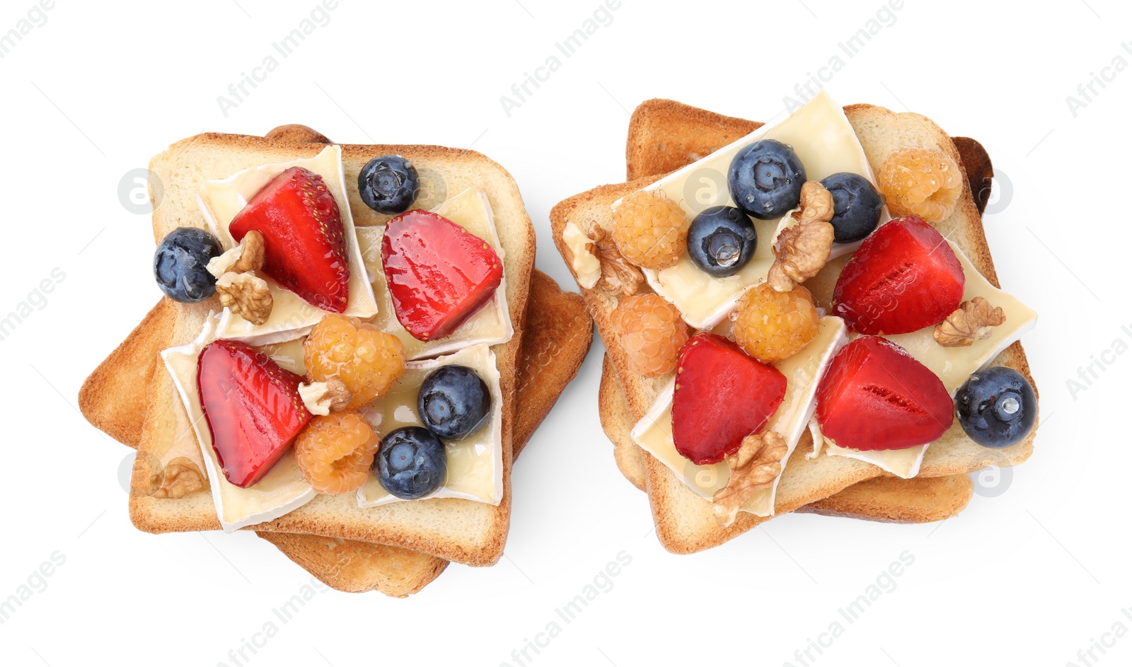 Photo of Tasty sandwiches with brie cheese, fresh berries and walnuts isolated on white, top view