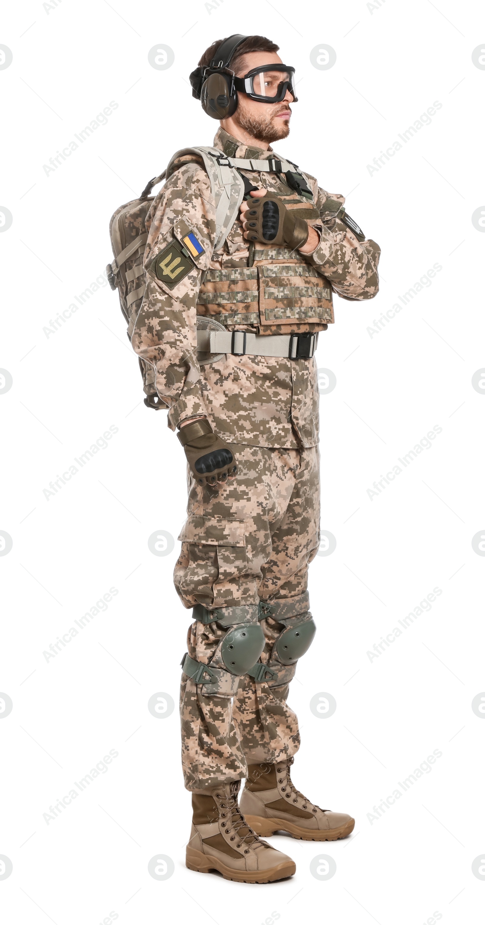 Photo of Soldier in Ukrainian military uniform, tactical goggles and headphones on white background