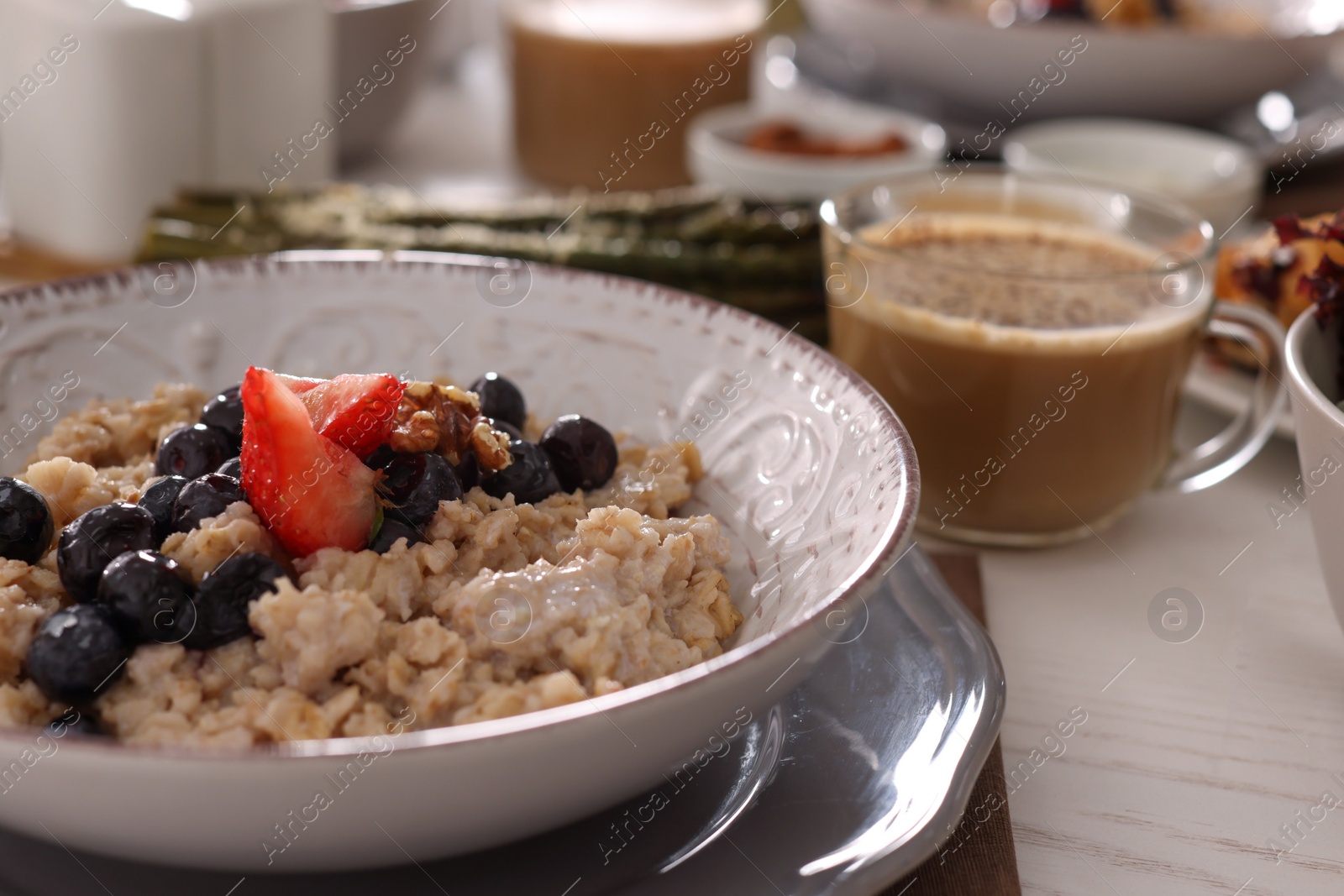 Photo of Oatmeal with fruits and nuts served on buffet table for brunch