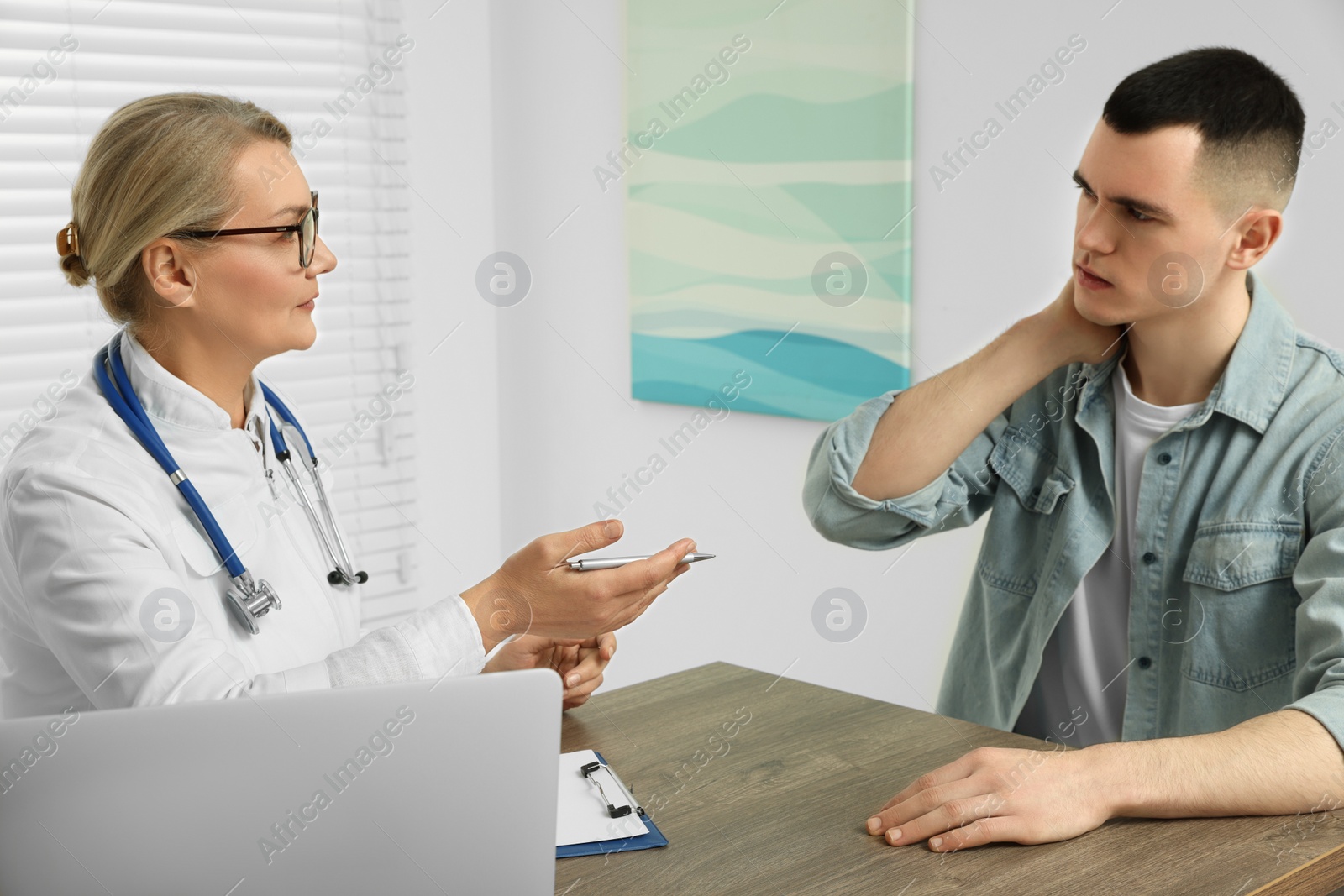 Photo of Professional doctor working with patient in clinic