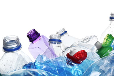 Photo of Pile of crumpled bottles on white background, closeup. Plastic recycling