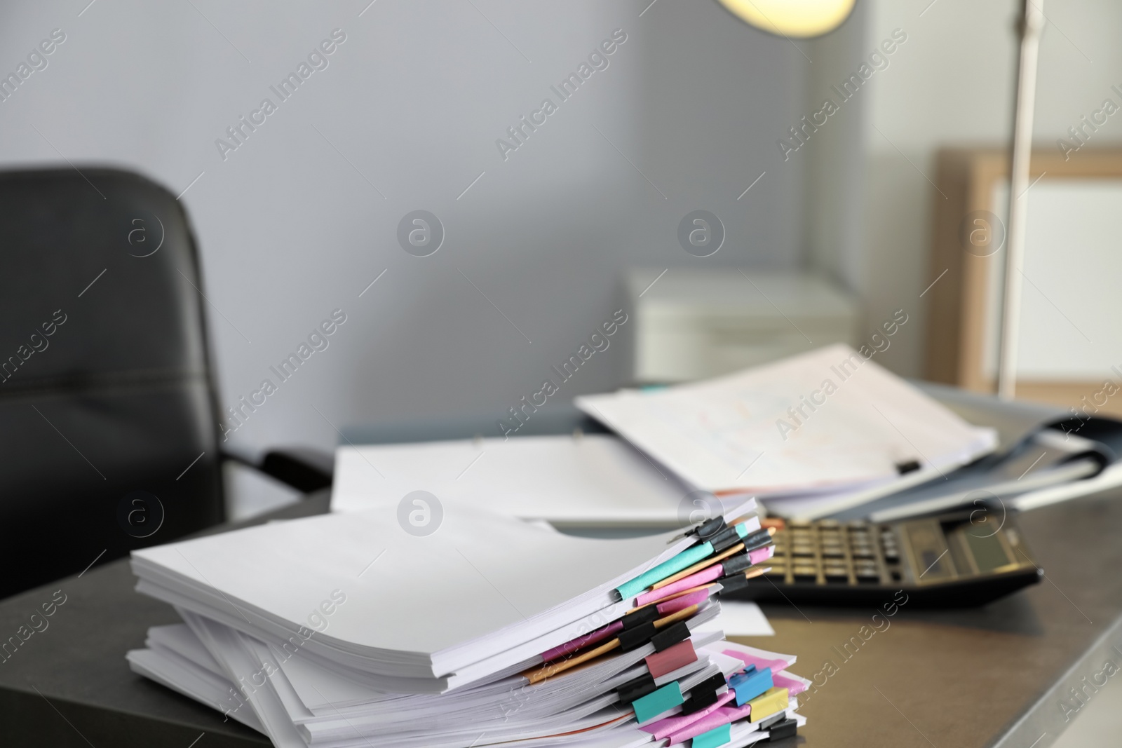 Photo of Stack of documents with paper clips on office table. Space for text