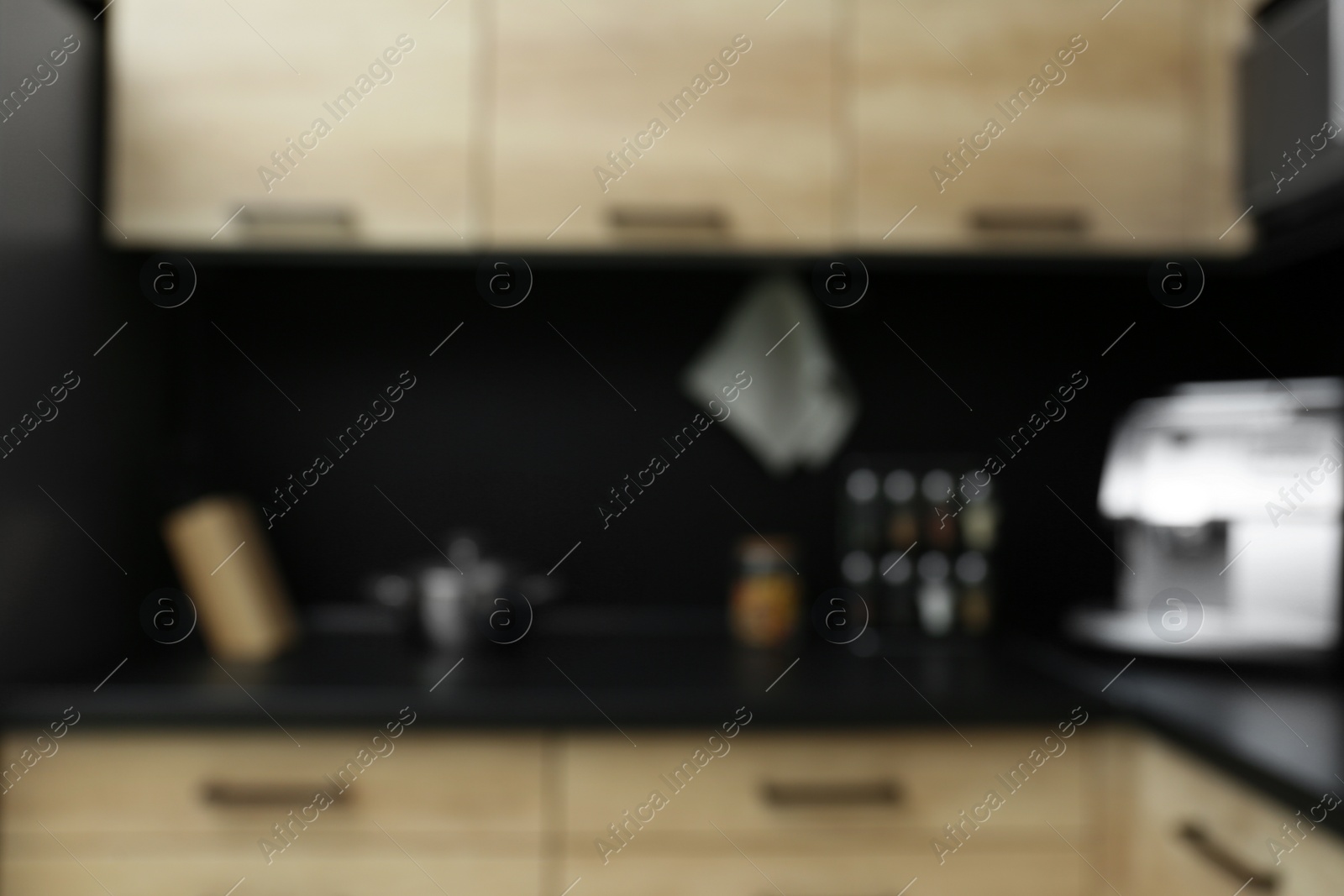 Photo of Blurred view of kitchen interior with modern furniture