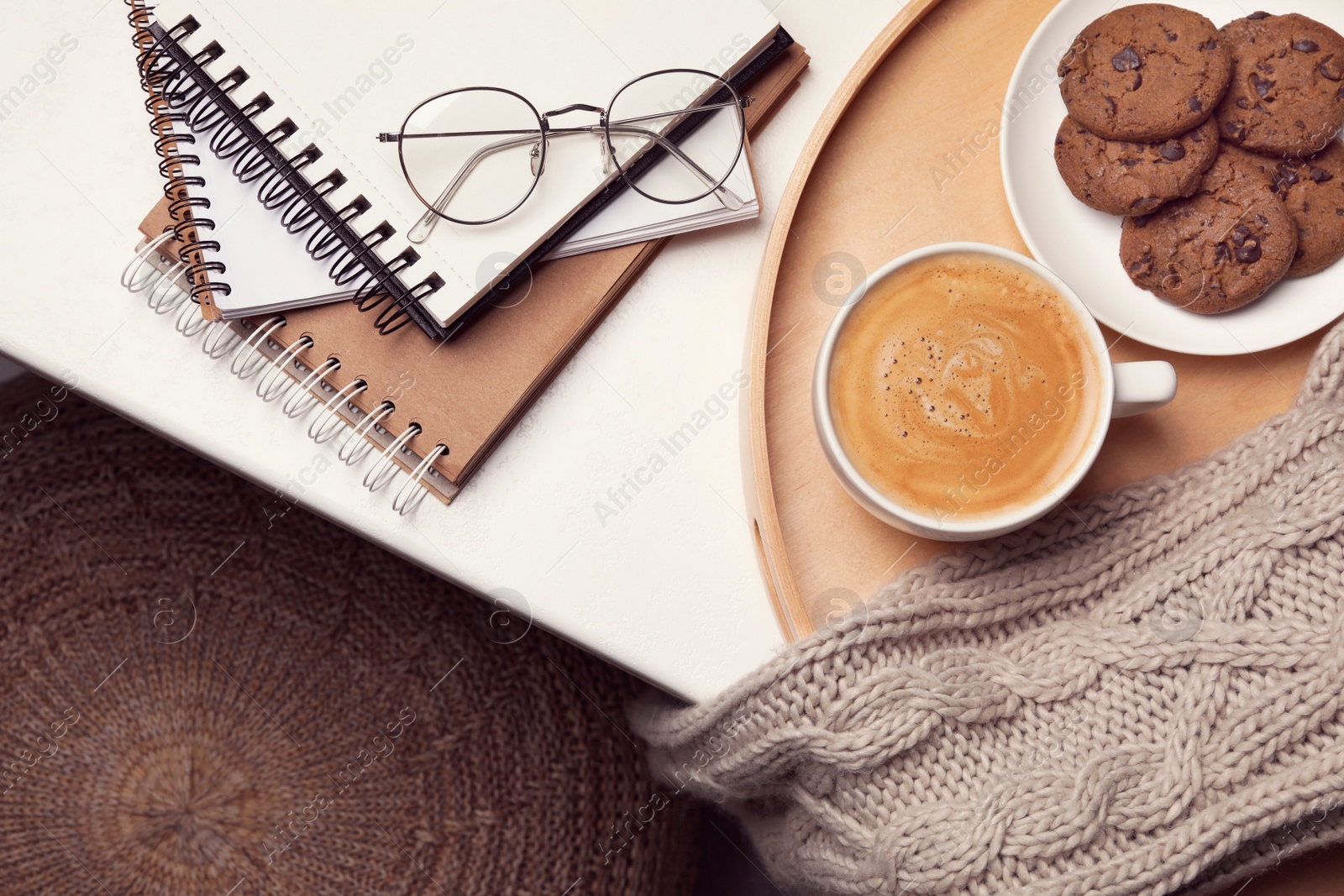 Photo of Cup of hot coffee and cookies on white table, top view. Winter drink