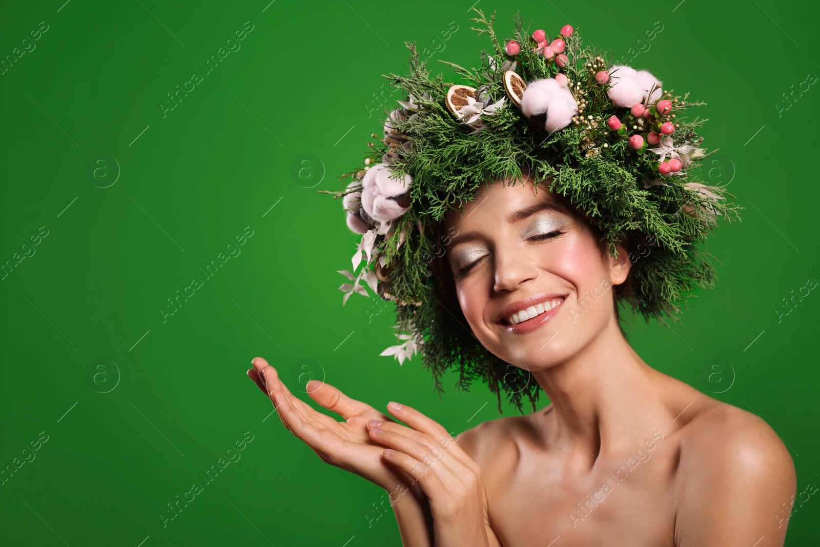 Photo of Happy young woman wearing wreath on green background. Space for text