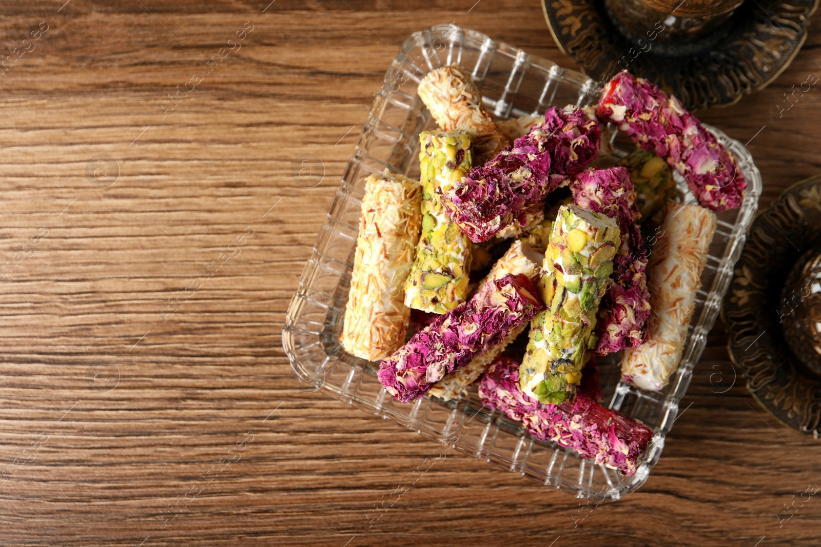 Photo of Turkish delight dessert on wooden table, top view. Space for text