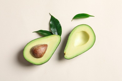 Ripe sliced avocado on light background