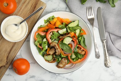 Photo of Delicious salad and bowl of mayonnaise on white marble table, flat lay