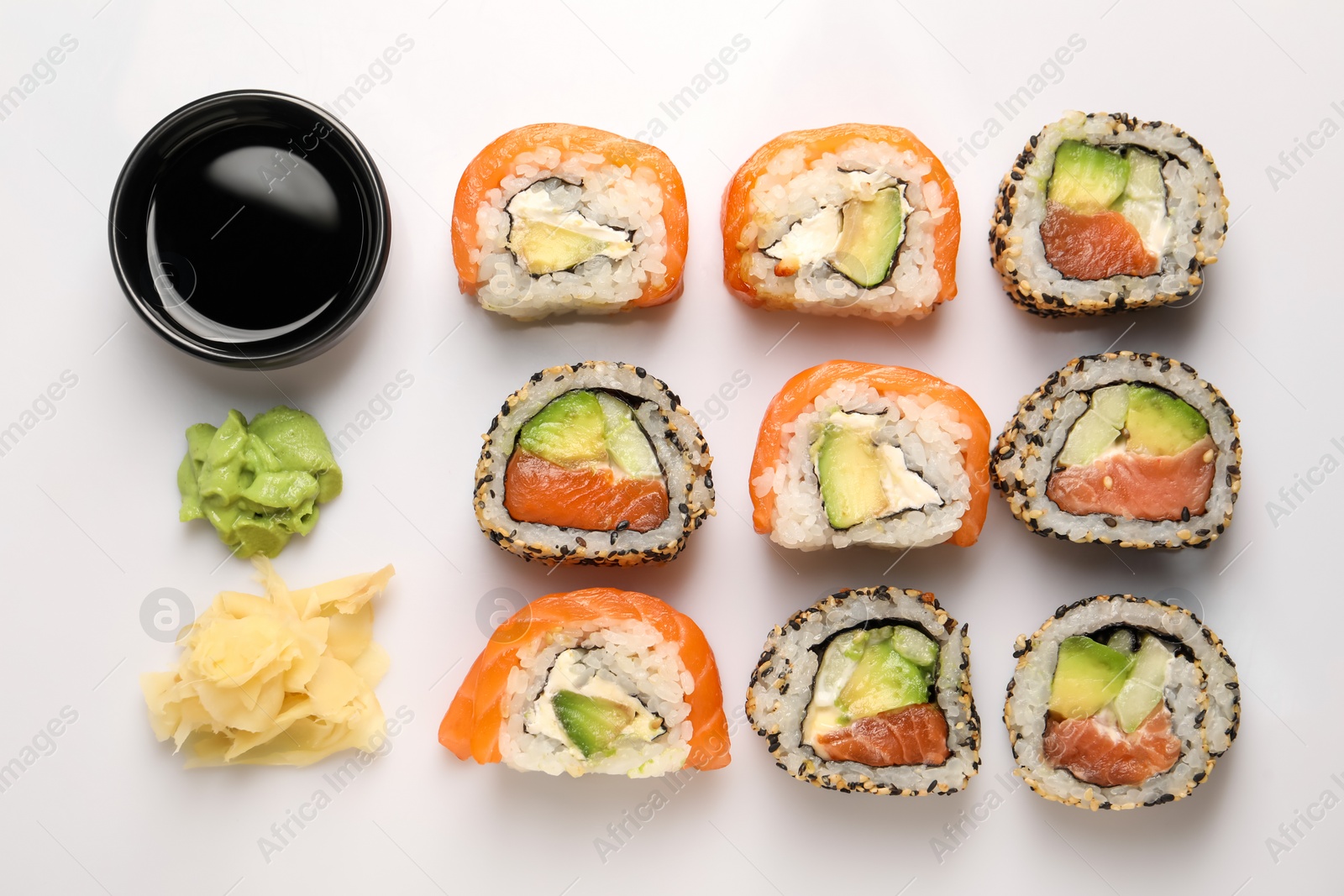 Photo of Delicious sushi rolls on white background, flat lay