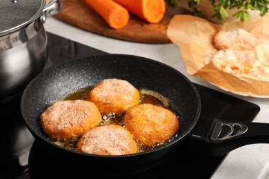 Cooking vegan cutlets in frying pan on stove