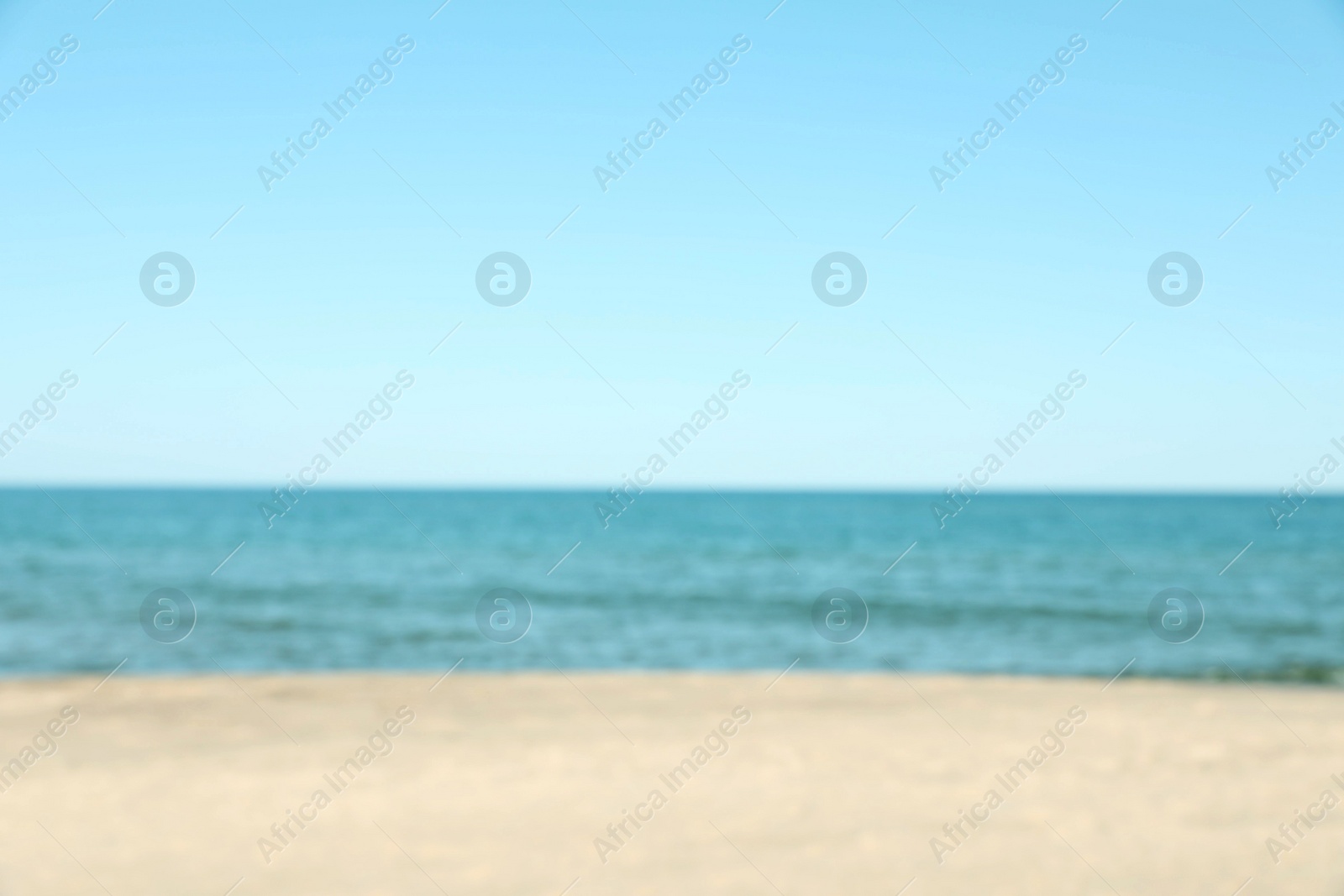 Photo of Blurred view of sandy beach near sea