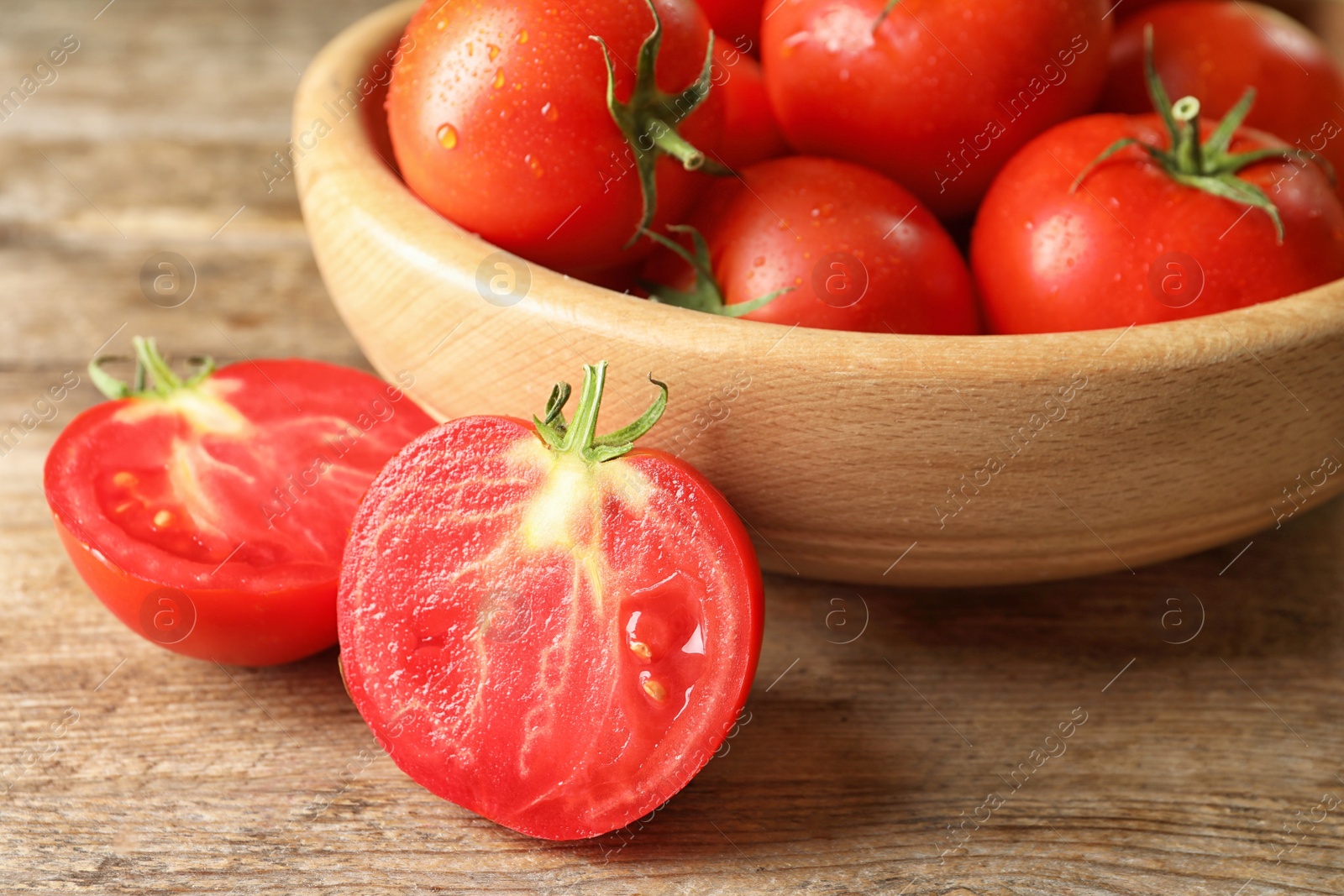 Photo of Fresh ripe tomatoes on wooden table, closeup