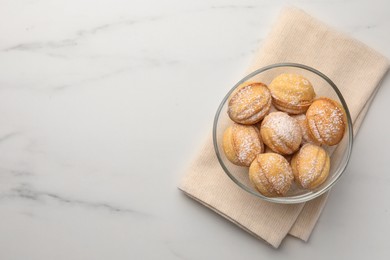 Photo of Homemade walnut shaped cookies with condensed milk on white marble table, top view. Space for text