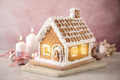 Beautiful gingerbread house decorated with icing on light table