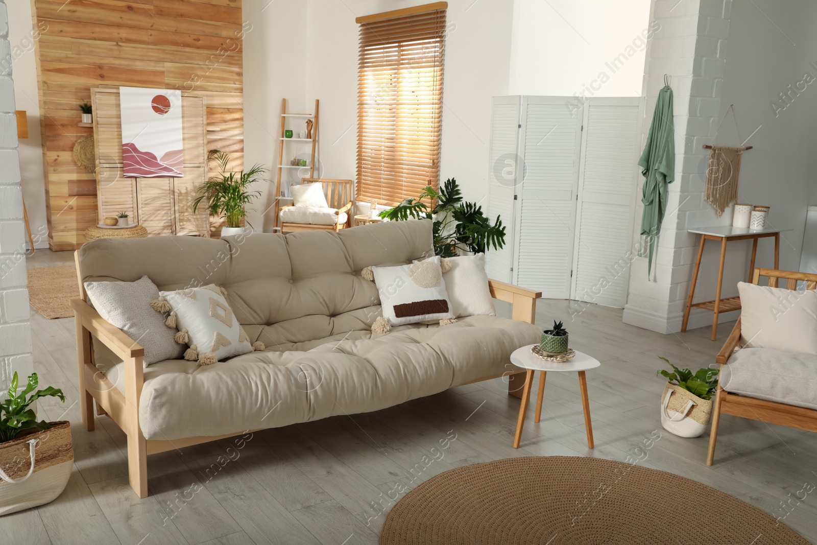 Photo of Spacious room interior with stylish wooden sofa and table. Idea for design