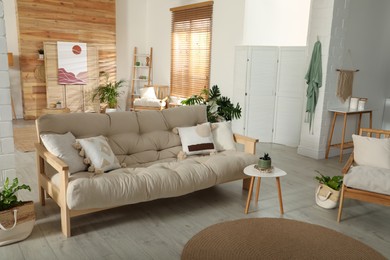 Photo of Spacious room interior with stylish wooden sofa and table. Idea for design