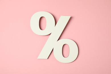 White percent sign on pink background, top view