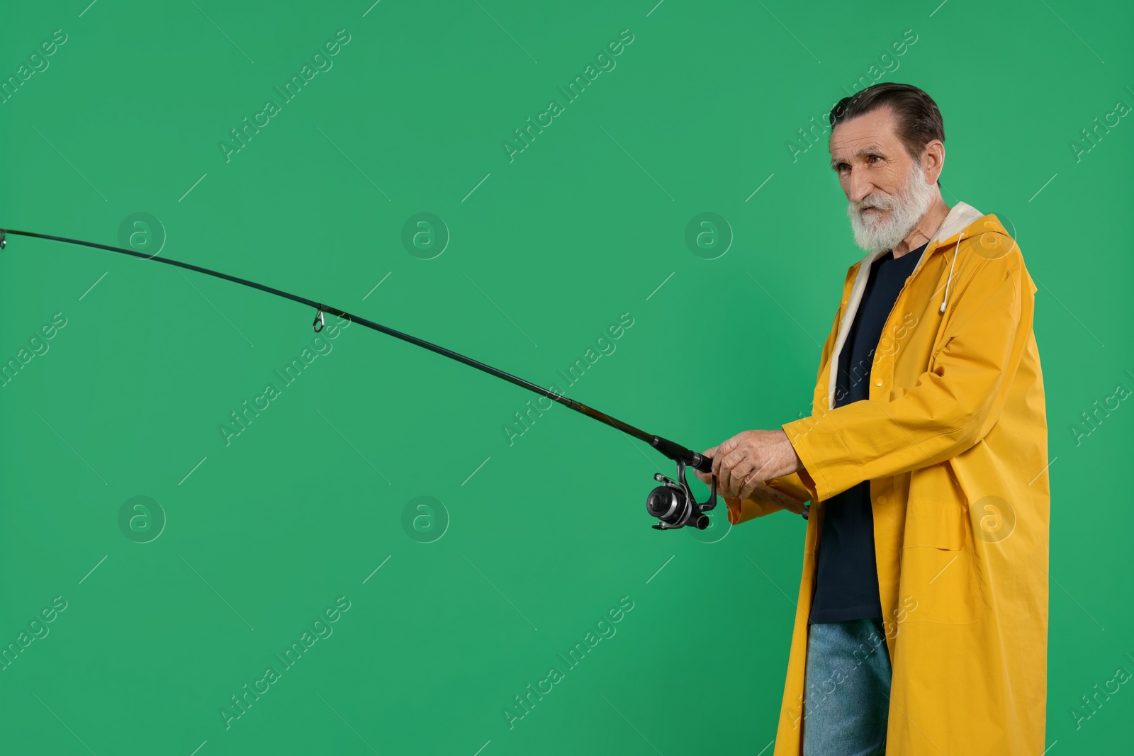 Photo of Fisherman with fishing rod on green background