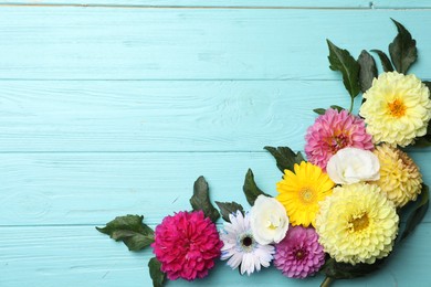 Photo of Flat lay composition with beautiful dahlia flowers on blue wooden background. Space for text