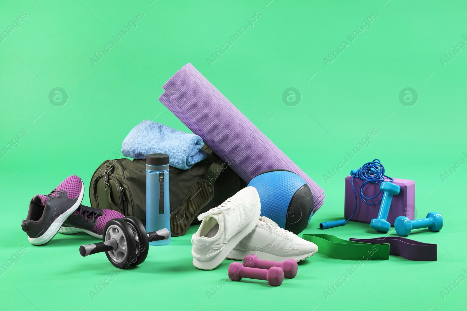 Photo of Many different sports equipment on green background