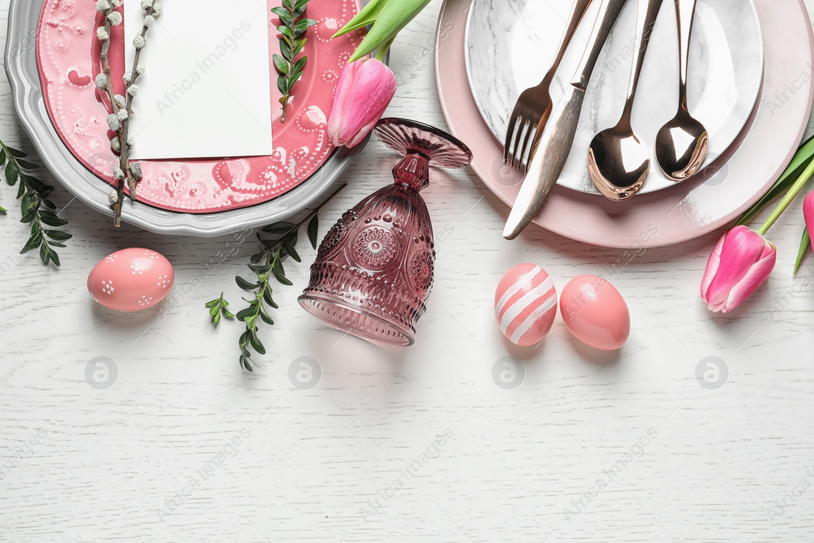 Photo of Festive Easter table setting with blank card on wooden background, flat lay