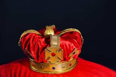 Photo of Beautiful velvet crown on red pillow. Fantasy item