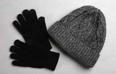 Stylish gloves and hat on grey background, flat lay