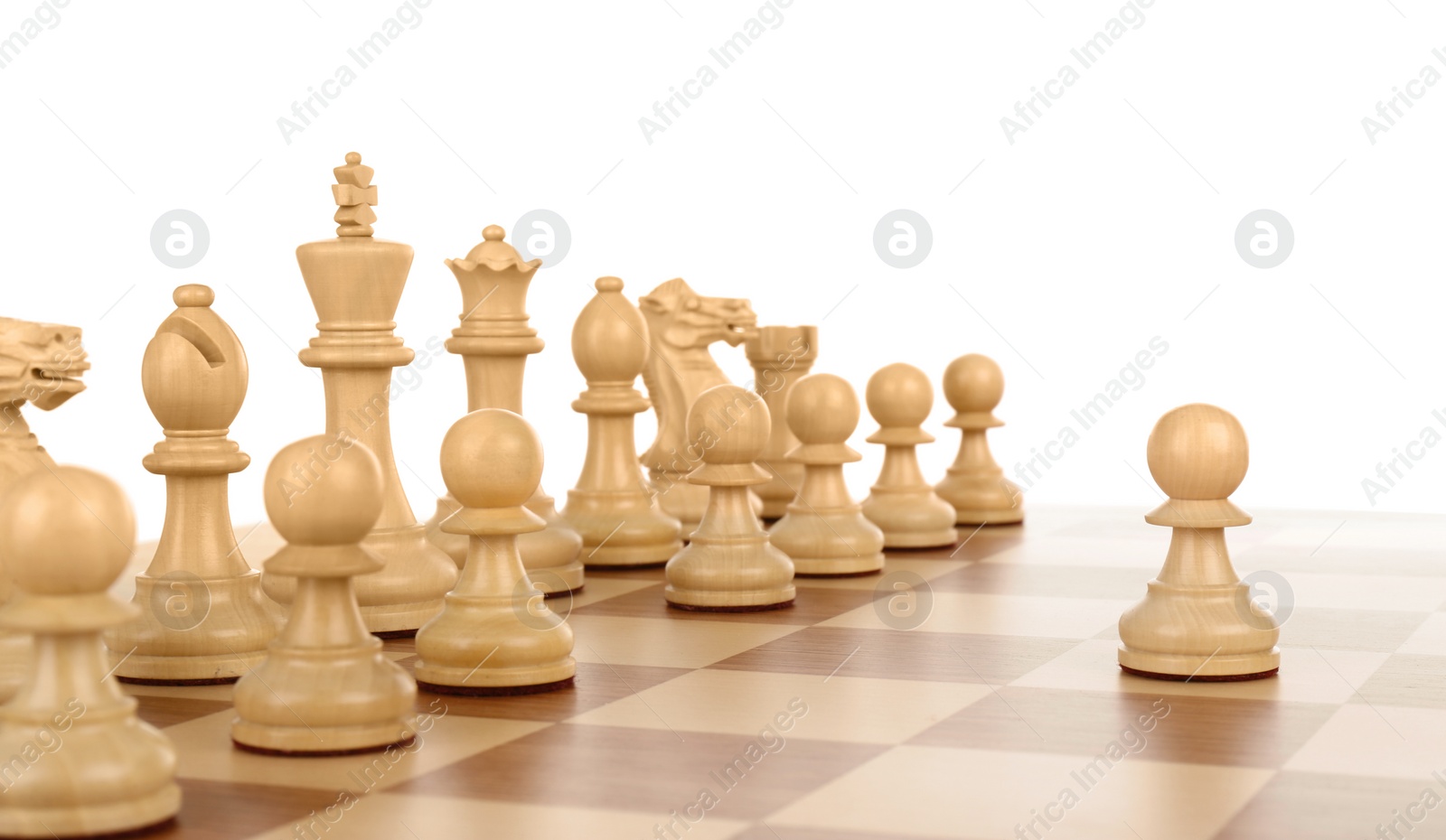 Photo of Pawn in front of other chess pieces on wooden board against white background
