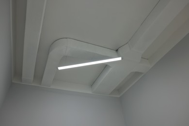 Ceiling with modern light in renovated room