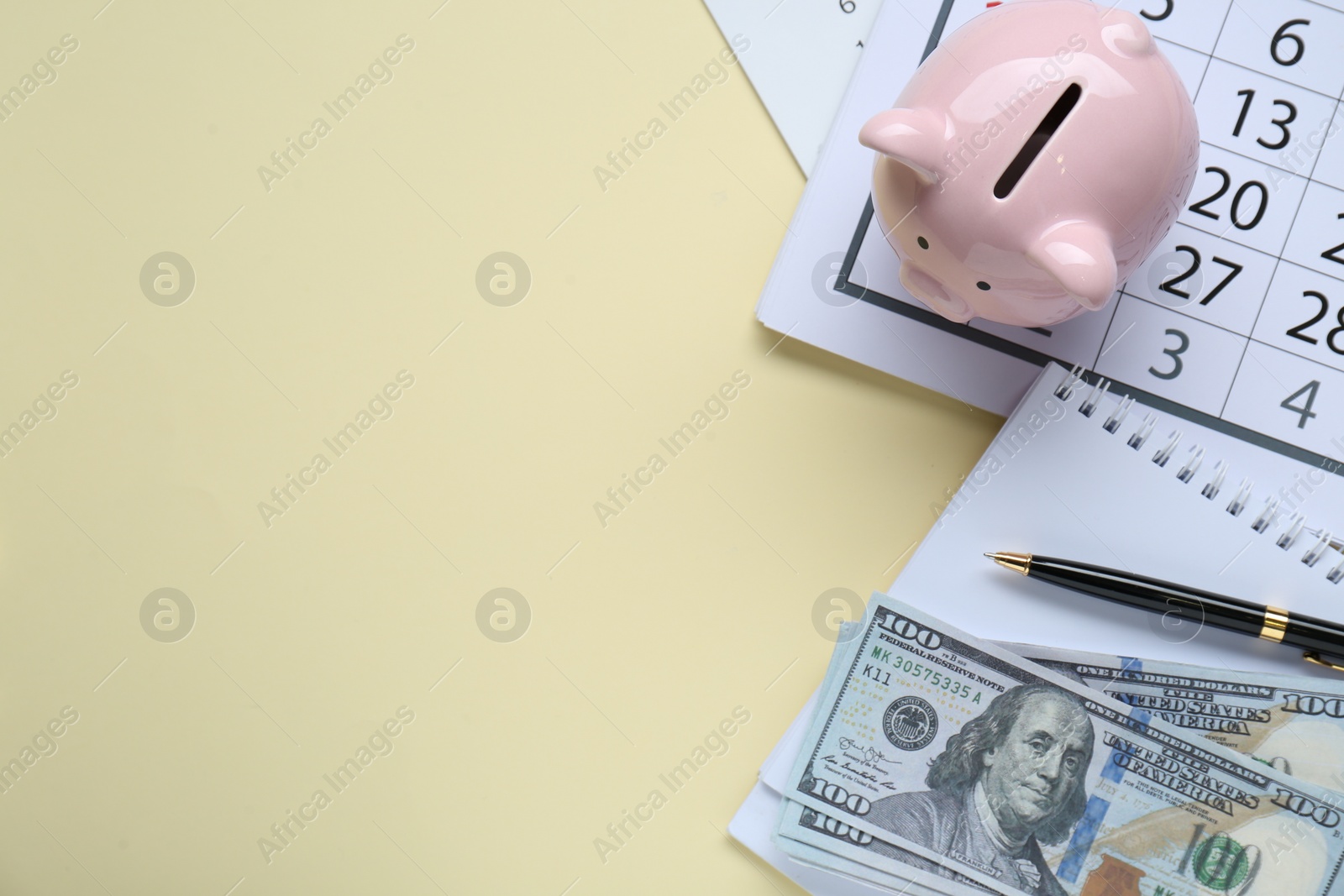 Photo of Flat lay composition with piggy bank and banknotes on beige background. Space for text