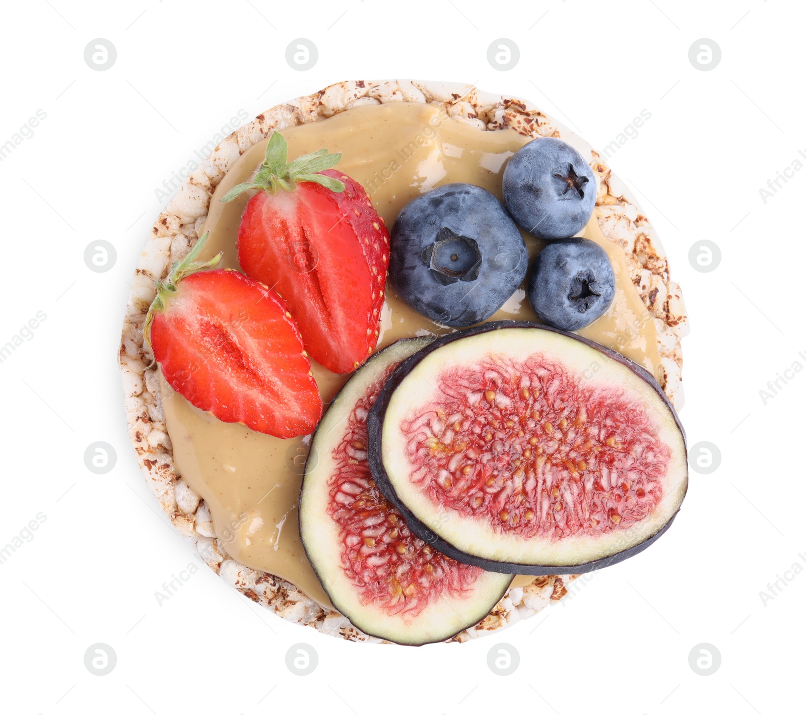 Photo of Tasty crispbread with peanut butter, berries and figs on white background, top view