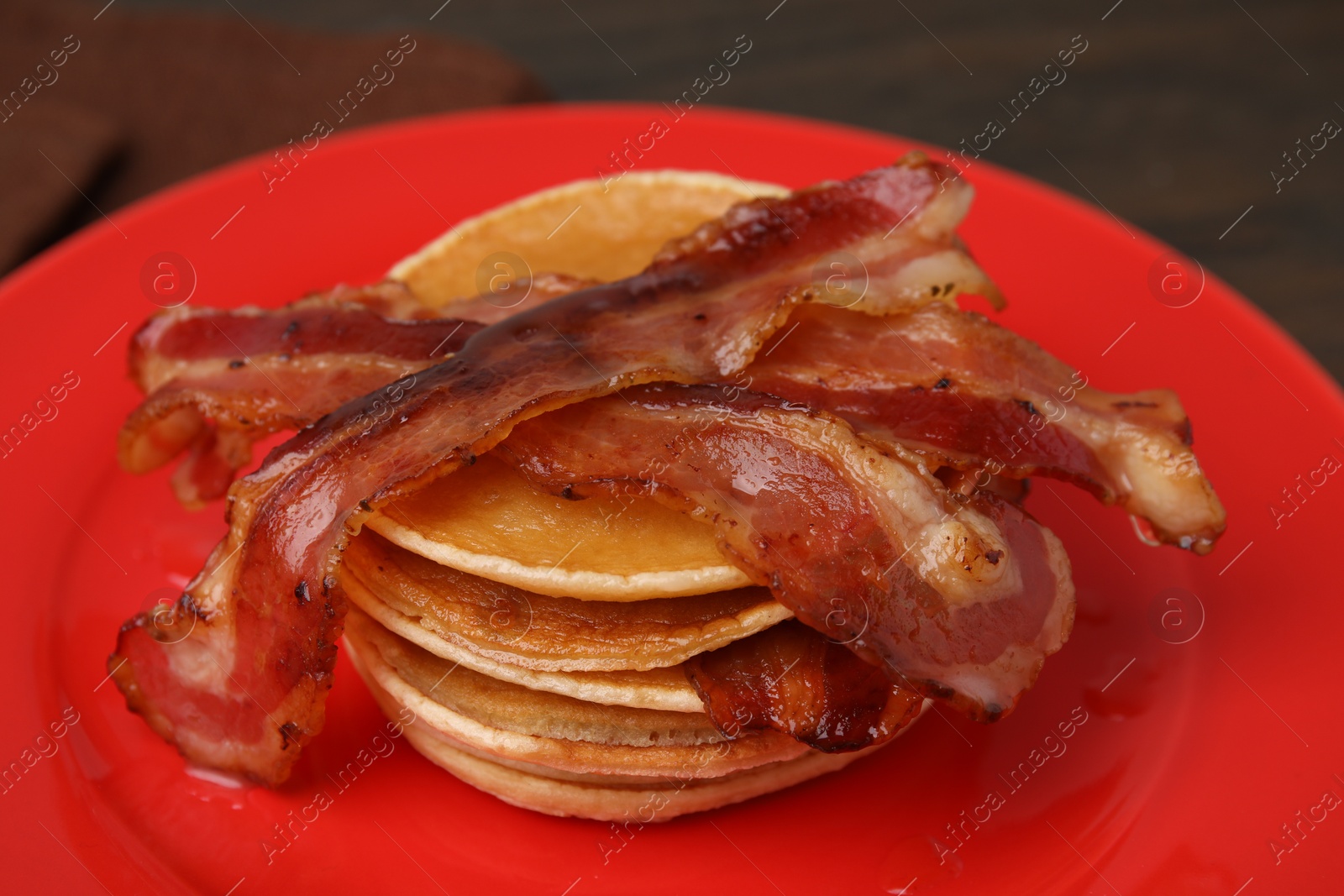 Photo of Delicious pancakes with bacon on table, closeup