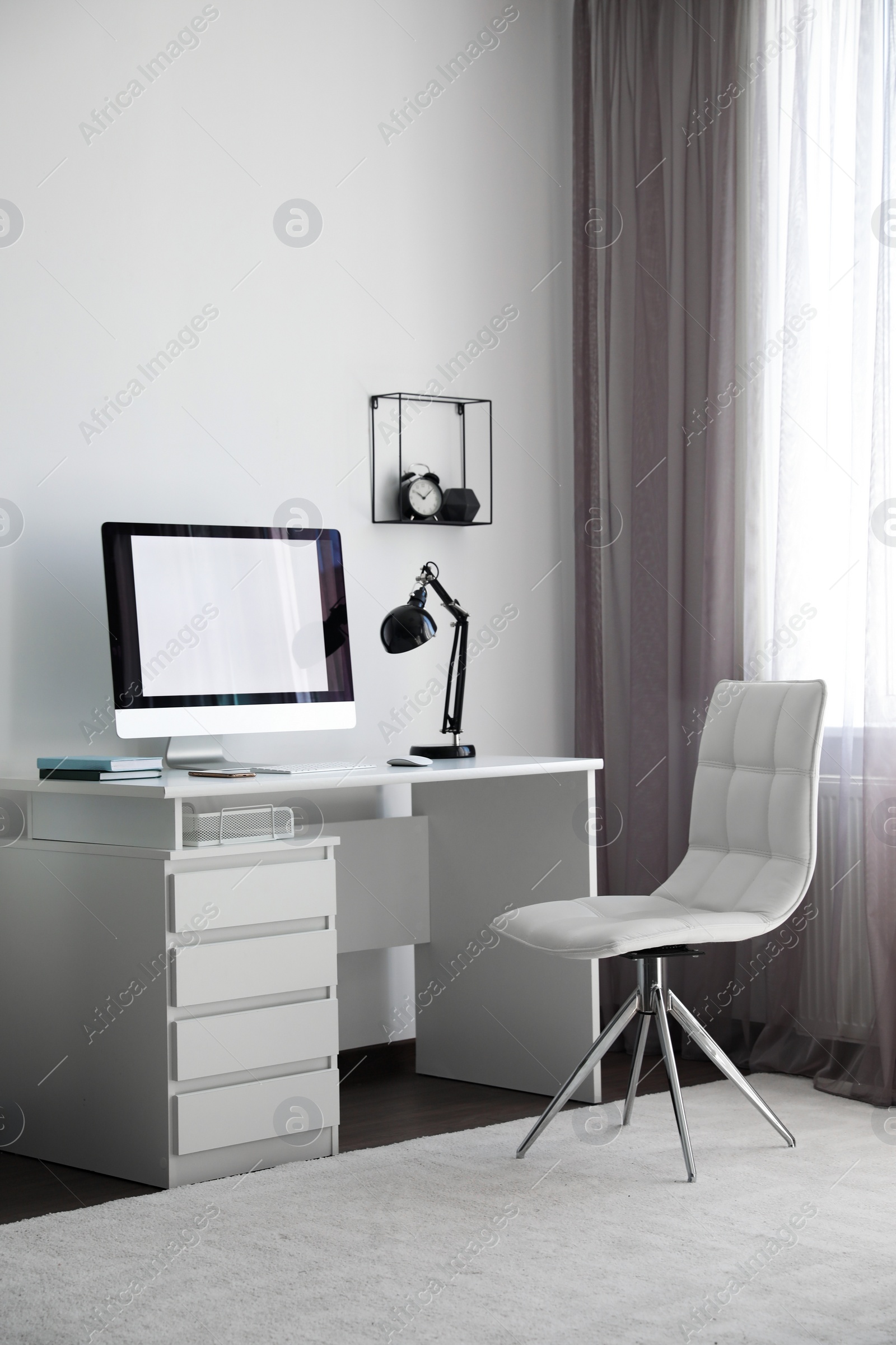 Photo of Comfortable white chair near desk in stylish office interior