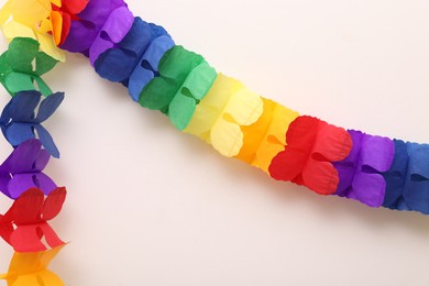 Photo of Rainbow paper garland on beige background. LGBT pride