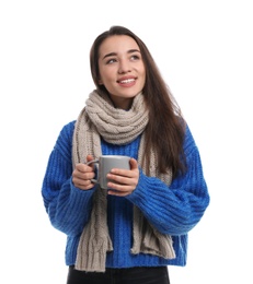 Photo of Young woman with cup of hot coffee on white background. Winter season