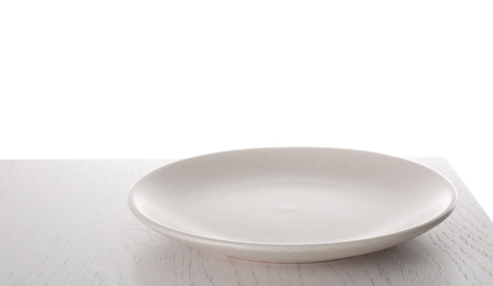 Photo of Clean empty plate on wooden table against white background