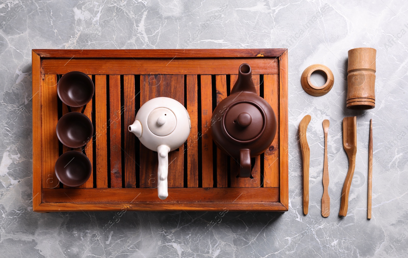 Photo of Beautiful set for traditional tea ceremony on light grey marble table, flat lay