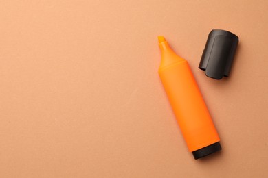 Photo of Bright marker on pale orange background, flat lay. Space for text