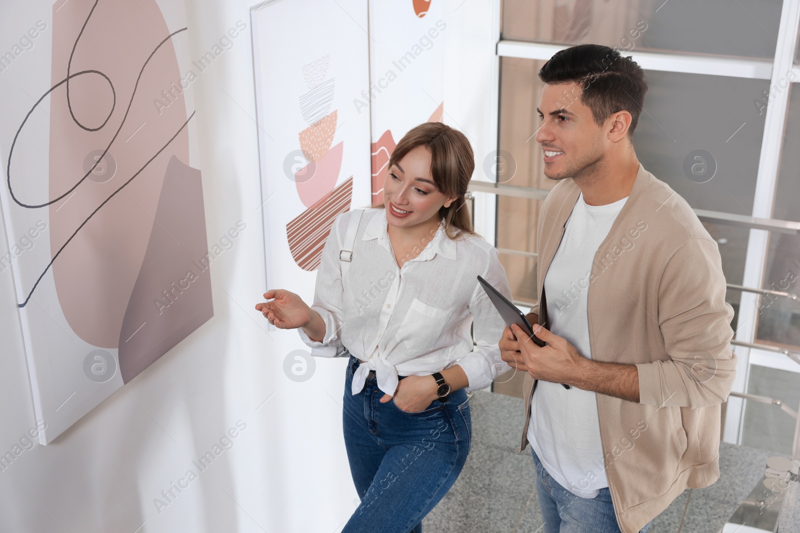 Photo of Happy couple at exhibition in art gallery