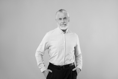 Portrait of handsome senior man on light background. Black and white effect