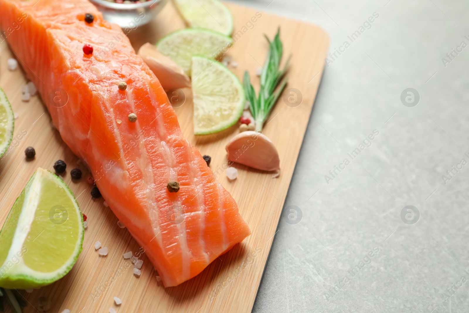 Photo of Fresh salmon and ingredients for marinade on wooden board