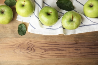Photo of Flat lay composition of fresh ripe green apples on wooden background, space for text