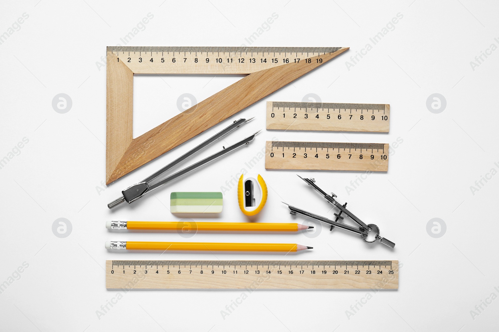 Photo of Different rulers and stationery on white background, top view