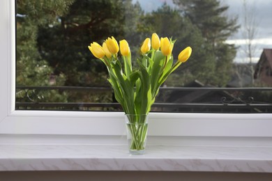 Photo of Wonderful tulips on window sill indoors. Spring atmosphere